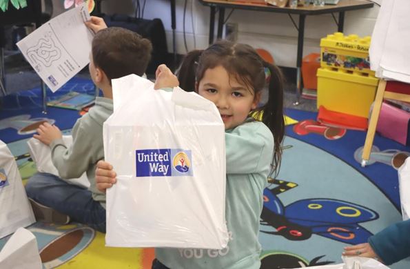 Child holding United Way bag