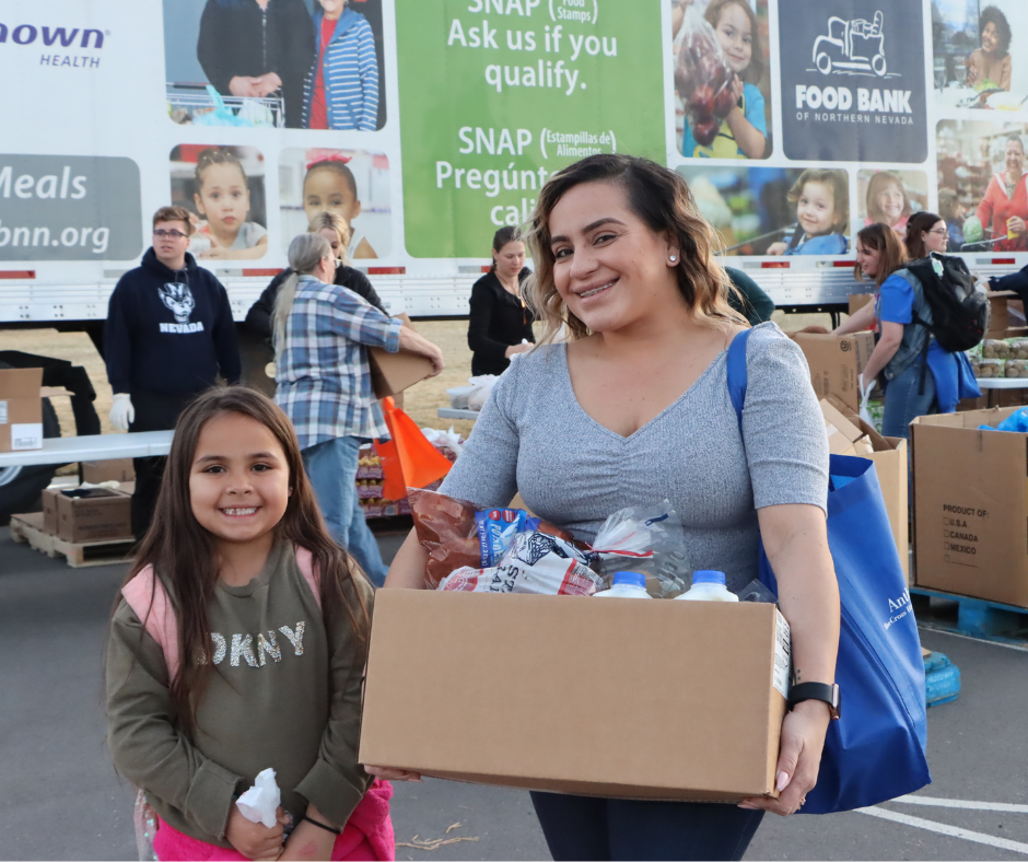 Family standing in front of Food Bank's Mobile Harvest Truck. 