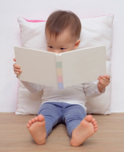 Baby reading book for Dolly Parton's Imagination Library